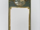 an ornately decorated mirror in the corner of a room