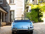 a blue car that is parked in front of a house