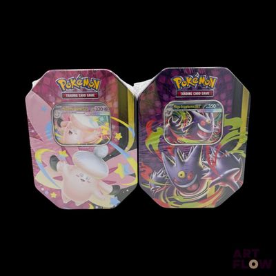 two tins of pokemon cards are sitting side by side on a black background