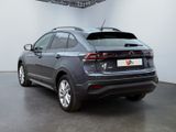 the rear end of a grey volkswagen suv parked in a garage