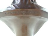 a bronze bust of a man with a name engraved on it