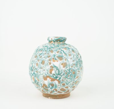 a blue and white vase sitting on a white surface