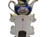 a tea pot that is sitting on top of a tree stump