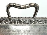 a silver metal box with a handle on a table