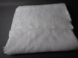 a folded white towel on a black table