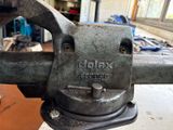 a close up of a metal vise on a table