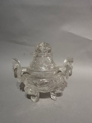 a small glass bowl with a lid on a table