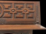 a wooden bench that has a carved design on it