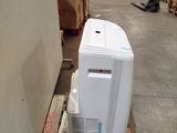 a small air conditioner sitting on a pallet in a warehouse