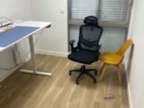 a desk with a chair and a computer on top of it