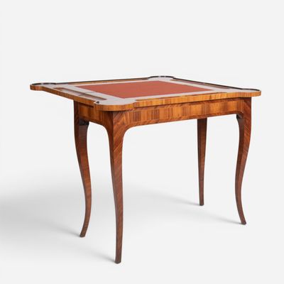 a wooden table with a red leather top and legs