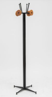 a black coat stand with two wooden hooks on it