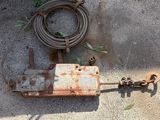 a rusted metal object on the ground next to a hose
