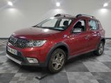 une photo d'une Dacia rouge garée sur un sol à damier