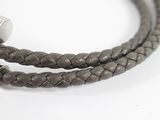 a close up of a leather bracelet with a metal clasp