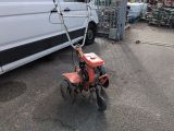 a small red bike parked in front of a white van