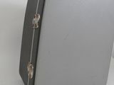 a gray suitcase sitting on a white surface