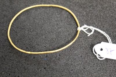 a close up of a bracelet with a tag attached to it