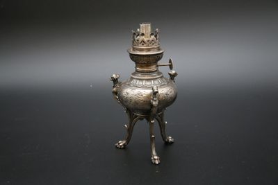 une image représentant un brûle-parfum en métal argenté surmonté d'une couronne