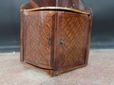a small wooden cabinet with a door on it
