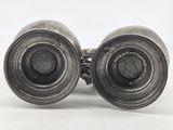 pair of antique silver plated binoculars on a white background