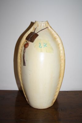 a vase with a bug on it sitting on a table
