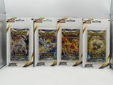 four packs of pokemon trading cards in a display case
