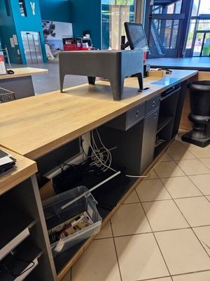 a desk with a computer on it in a restaurant