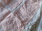 a bed with a pink and white bed spread and a pink and white bed spread