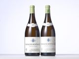 two bottles of wine sitting on top of a table next to each other
