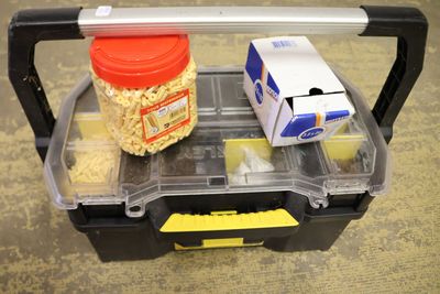 a plastic container with some food in it on the floor