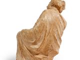 an image of a statue of a woman sitting on a chair