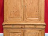 an image of a wooden cabinet against a red wall