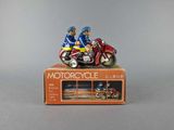 figurines of two people on a motorcycle on a box