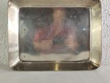 a reflection of a woman in a mirror on a table