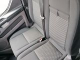 the back seats of a car with a seat belt and a steering wheel