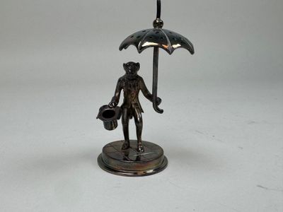 a bronze statue of a man holding an umbrella