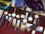 a lot of watches that are sitting in a case