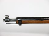 a close up of a rifle with a wooden handle on a white background