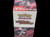 a close up of a box of pokemon trading cards on a black background