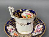 a close up of a cup and saucer on a table