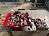 a red tool box filled with tools on a table
