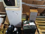a refrigerator and microwave sitting on a pallet in a warehouse