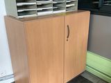 a cabinet that has a bunch of papers on top of it