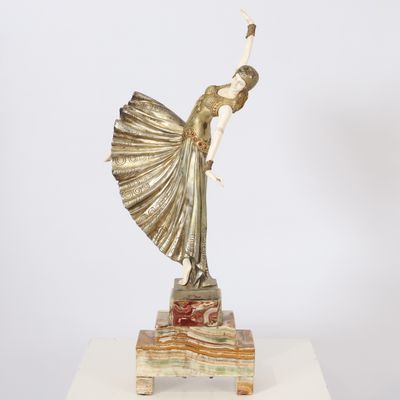 a statue of a woman holding a fan on a marble base