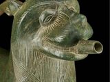 a statue of a horse with a long neck and a long tail