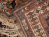 an image of a close up of a rug with fringes on it