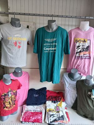 a lot of t - shirts on display in a store
