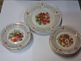 three plates with fruit on them sitting on a table