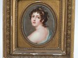 portrait of a young woman in a blue dress by a gold frame